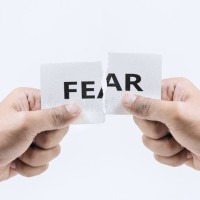hand-tearing-paper-fear-word-white-tone-background-business-success-concepts.jpg